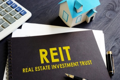 To avoid taxation at the corporate level, a REIT must derive at least ¾ of its income from real property and must distribute what percentage of its net income to shareholders?